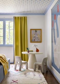 a living room with yellow curtains and white furniture