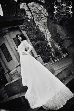 black and white photo of woman in wedding dress posing for the camera with her hands on her hips