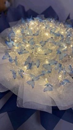 a blue and white flower with lights in it