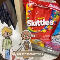 a bag of skittles next to a paper cutout of a boy and girl