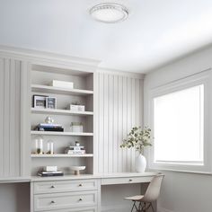 a white desk and some shelves in a room