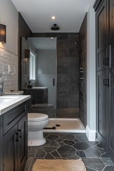 a bathroom with dark wood cabinets and tile flooring, along with a walk in shower