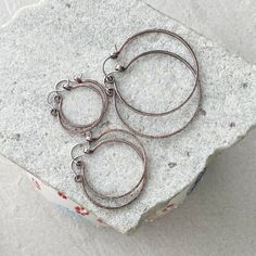 You will receive 1 pair of hoop earrings in the size you select from the drop down menu. approx. size measurments: Size Small- 25mm / just under 1.25" long size Medium- 35mm / 1.5" long Size Large- 45mm /  2" long Materials- copper wire- oxidized and polished to a pretty antique hue ear wires- sterling silver weight- light  weight If you have any questions regarding this or another design. You can contact me via-Etsy conversation. Best Wishes! Joella Everyday Adjustable Small Hoop Wrap Earrings, Small Hoop Metal Wrap Earrings, Everyday Metal Hoop Wrap Earrings, Everyday Metal Hoop Earrings With Ear Wire, Everyday Handmade Metal Hoop Earrings, Everyday Round Metal Clip-on Earrings, Everyday Metal Hoop Clip-on Earrings, Handmade Metal Wrap Earrings, Everyday Metal Clip-on Earrings