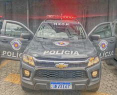 three police cars parked in front of a building