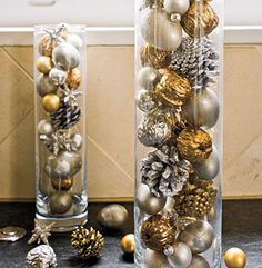 two tall clear vases filled with ornaments