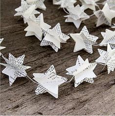 white paper stars are arranged on a wooden surface