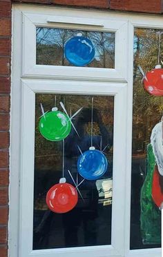 a santa clause looking out the window with christmas decorations hanging from it's windows