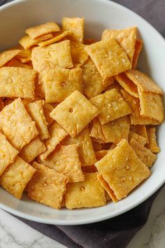 a white bowl filled with crackers on top of a table