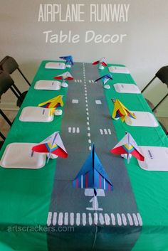 the table is set with paper airplanes on it