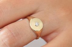 "Diamond Signet Ring / 14k Solid Gold Bezel Setting Diamond Pinky Ring / Pinky Signet Ring / Promise Ring / Minimalist Diamond Ring Item Details * Made to Order. * Gold Kt: 14K Solid Gold * Custom Gold Color: Rose Gold, Yellow Gold, White Gold * Width of Round Signet: 9MM * Round Diamond: 2.5MM * Total Number of Stones: 1 * Total CTW: 0.07 * Diamond Color Clarity: G Color Si1 Clarity * Setting Type: Bezel Setting * Band Width: Graduates from 9MM to 1.25MM * Ready to Ship in 7-10 Business Days If Diamond Pinky Ring, Infinity Knot Ring, Spinel Jewelry, Pinky Signet Ring, Minimalist Diamond Rings, Diamond Signet Ring, Vintage Gold Rings, Spinel Ring, Topaz Engagement Ring