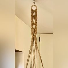 a bunch of ropes hanging from the ceiling in a room with white walls and flooring