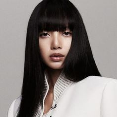 a woman with long black hair and bangs