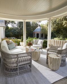 an outdoor living area with wicker furniture