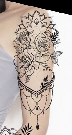 a woman's arm with roses and leaves tattoo on the side of her body