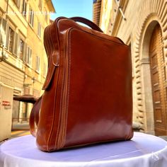 This Italian leather Backpack is a true masterpiece of craftsmanship. Handmade in Florence, Italy, it combines luxurious materials and exquisite attention to detail. Elevate your style and travel in sophistication with this elegant backpack. . Size: Height 44cm/17.4 inch Width 32cm/12.6 inch Depth 12cm/4.8 inch . The story of this backpack: In the vibrant city of Florence, Italy, a small artisan workshop nestled amidst the cobblestone streets hummed with creativity and passion. Here, a skilled craftsman named Alessio dedicated himself to the art of crafting exquisite handmade leather goods. His attention to detail and commitment to quality resulted in remarkable creations, including a collection of leather backpacks that were both functional and stylish. One day, a young student named Marc Luxury Brown Backpack For Daily Use, Luxury Brown Rectangular Leather Backpack, Classic Backpack As Gift, Luxury Leather Backpack With Adjustable Strap, Luxury Rectangular Backpack With Adjustable Strap, Luxury Formal Satchel Backpack, Luxury Brown Rectangular Backpack, Luxury Brown Satchel Backpack, Luxury Leather Lined Backpack Shoulder Bag