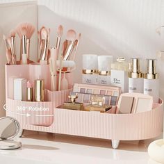 an organized pink makeup holder on a counter