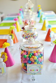 a table topped with lots of candy covered jars