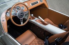 the interior of an old model car with leather seats and steering wheel, including dashboard