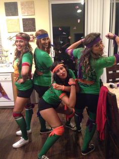 a group of women in costume standing next to each other on a hard wood floor