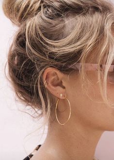 a woman with large hoop earrings on her ear