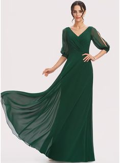 a woman in a long green dress with sleeves on her shoulders and an open back