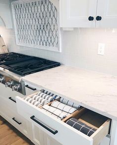 an open drawer in the middle of a kitchen counter