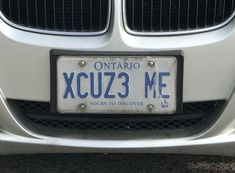 a license plate on the front of a silver car