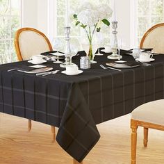 a dining room table set with place settings