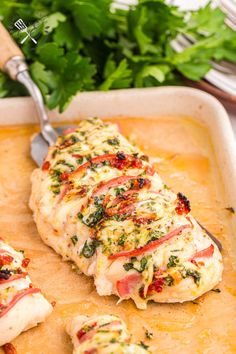 a piece of chicken covered in sauce and garnished with parsley