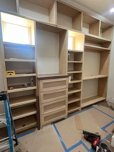 an empty room with shelves and tools on the floor