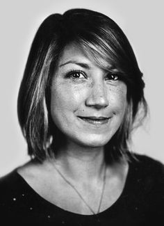 a black and white photo of a woman smiling