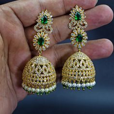 Experience the epitome of traditional Indian elegance with these exquisite 22K yellow gold plated CZ diamond crystal Nakshatra drop dangle Jhumka earrings. Crafted with meticulous attention to detail, these earrings feature a classic South Indian design that is perfect for ethnic occasions. The intricate patterns and sparkling crystals add a touch of glamour to any ensemble, making them a must-have accessory for every modern Indian woman. Lightweight and comfortable to wear, these earrings dangl Gold Plated Cutdana Jhumkas As Gift, Hand Set Gold Plated Temple Jewelry Jhumkas, Gold Plated Hand Set Jhumkas In Temple Jewelry Style, Gold Plated Hand Set Jhumkas Temple Jewelry, Gold Plated Hand Set Temple Jhumkas, Traditional Festive Bridal Earrings With Cubic Zirconia, Traditional Cubic Zirconia Bridal Earrings For Festive Occasion, Traditional Festive Cubic Zirconia Bridal Earrings, Festive Gold-plated Stone Work Jhumkas