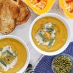 bowls of soup and bread on a table