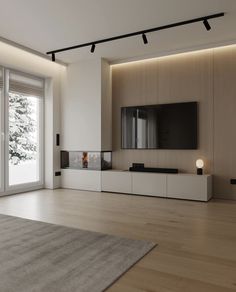 an empty living room with wood floors and white walls, large sliding glass doors to the outside