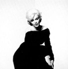 a black and white photo of a woman in a dress