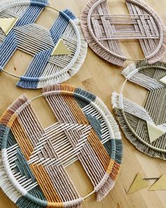 four woven baskets sitting on top of a wooden table