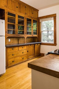 a kitchen with wooden cabinets and white appliances