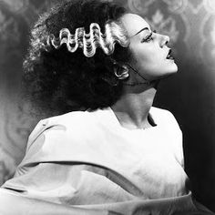 an old photo of a woman with curly hair in a bunt style hairstyle