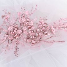 pink flowers and pearls on white fabric