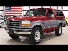 a red pick up truck parked in a garage