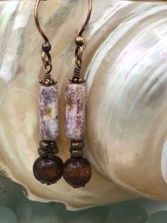 Handmade purple haze ceramic dangle earrings accented with bronze and wood earth tone beads. Unique  jewelry for your unique boho style and makes a great handmade gift. Hypoallergenic Purple Bohemian Earrings, Multicolor Earthy Dangle Earrings, Artisan Purple Beaded Dangle Earrings, Artisan Purple Earrings With Dangling Beads, Bohemian Purple Earrings With Czech Glass, Bohemian Handmade, Hippie Jewelry, Beaded Dangles, Wood Beads