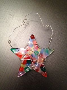 a glass star ornament hanging on a wall