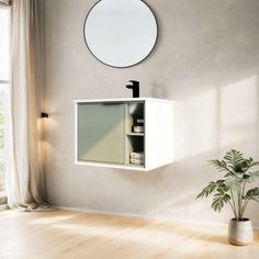 an empty room with a potted plant and round mirror on the wall