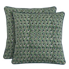 two green and black pillows with an animal print on the front, one is made out of