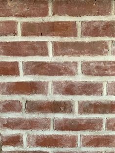 a brick wall that is made out of red bricks and has no mortar on it