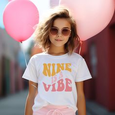 This Vibe Birthday shirt is the perfect birthday top for any groovy party. Customize for any age! Examples : Five is a Vibe, Nine is a Vibe. Perfect for your retro birthday, hippie birthday Groovy Vibes!  Our Birthday Baby graphic makes this a must have birthday shirt! ✨ HOW TO ORDER ✨ ✧ Select your options from the Drop Downs ✧ ADD TO CART * * * * * * * * * * * * * * * * * * * * * * * * * * * * * 👕 TOPS 👕 ✧T-SHIRT - soft cotton, crew neck unisex tee * * * * * * * * * * * * * * * * * * * * * * Good Vibes Only Birthday Party, 9th Birthday Shirt Girl, Trendy Pink Tops For Birthday, Pink T-shirt For Birthday In Summer, Pink Summer T-shirt For Birthday, Trendy Pink T-shirt For Birthday, Playful Letter Print Tops For Birthday, Pink Summer Tops For Birthday, 7 Is A Vibe Birthday Party