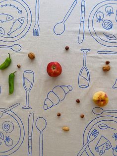 a table topped with lots of food and utensils on top of a white cloth