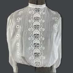 "This 1900s white blouse is really gorgeous! The hand embroidered designs are really lovely. The sleeves have horizontal ruched detailing and delicate lace at the wrist. The blouse closes with the tiniest of mother of pearl buttons down the back. The front features the pigeon front blousy style popular at the time. It's in very good condition for its age. There are a few small spots but no holes. Measurements Shoulder 14.75\" Bust 36\" Waist 23\" Sleeves 25\" Length 16\" Neck 12\" circumference" Eyelet Wedding Dress, The Pigeon, Lavender Blouse, Vintage Runway, Hippie Pants, Mesh Blouse, Cotton Bras, Special Occasion Outfits, Yellow Blouse