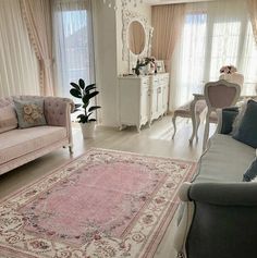 a living room filled with furniture and a pink rug