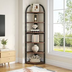 a living room with a large window and bookshelf